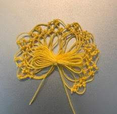 Paula Harten makes a ribbon using the knotted lace techniques. She is a Board Member of the Lace Museum in Sunnyvale California. Bobbin, needle, and finger lacemaker.